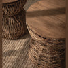 Macro close-up view focusing on the intricate hand-woven rattan pattern and organic texture of the pedestal base