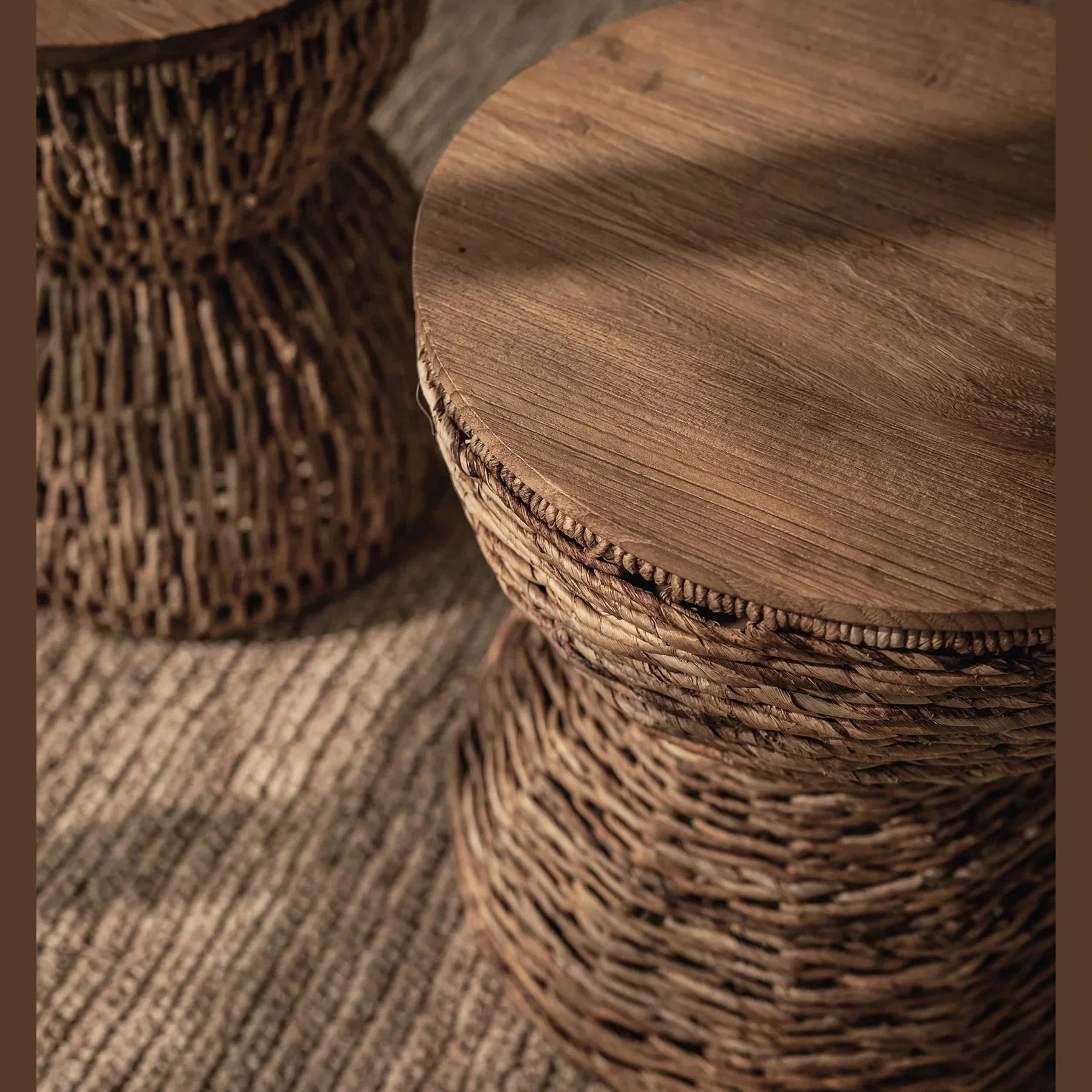 Front view of the D-Bodhi Rebana Alto side table featuring a hand-woven natural rattan hourglass base and a smooth circular reclaimed wood top