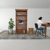 Perspective shot of the Rebana Alto table placed in a professional home office setting with a desk and chair