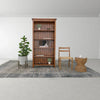 Interior view showcasing the table's versatile use as a plant stand or accent piece next to a wooden bookshelf