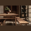 Three-quarter perspective view highlighting the thick tabletop and the authentic textured character of the reclaimed wood