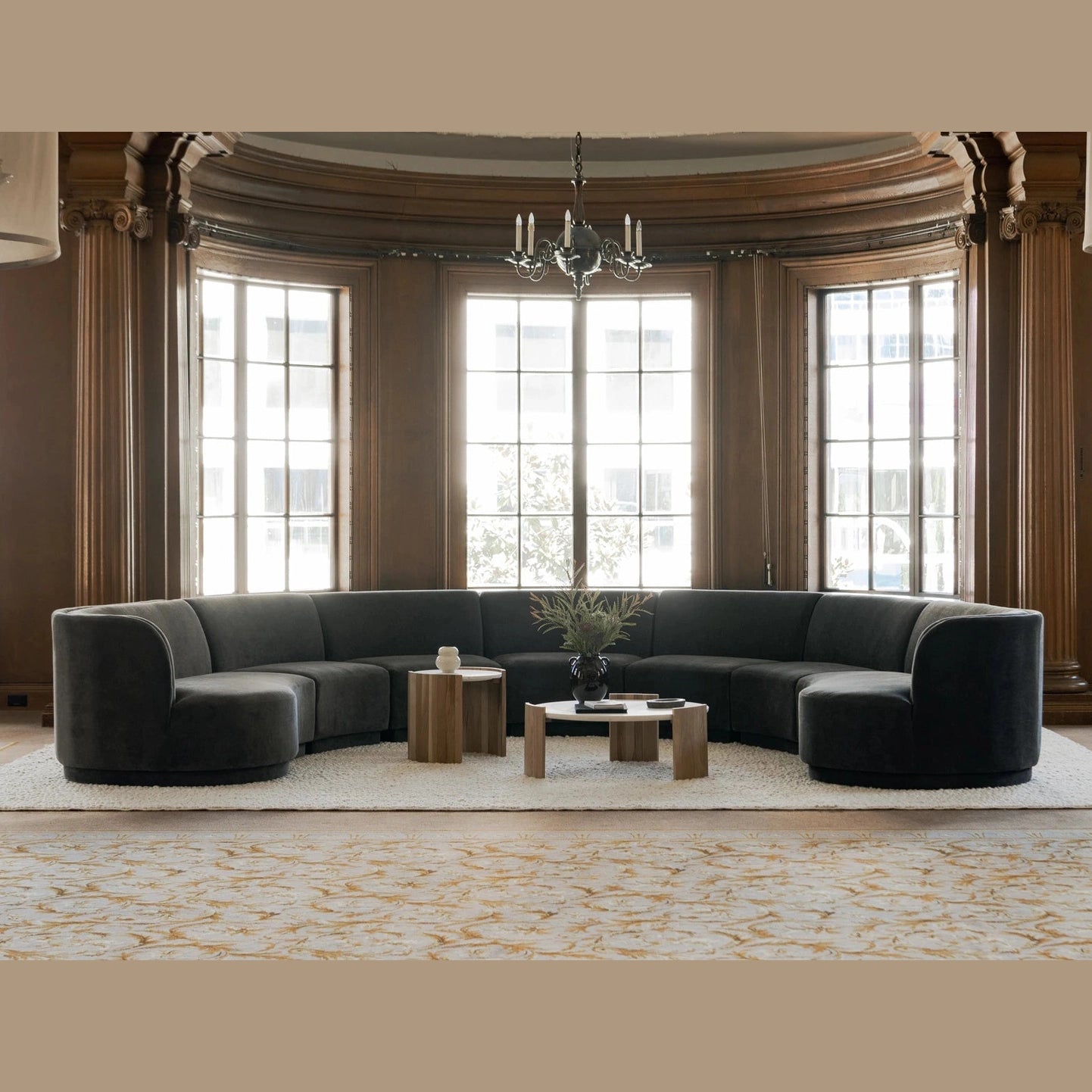Lifestyle shot of the Dala side table styled in a luxurious circular living room setting with a large curved sofa