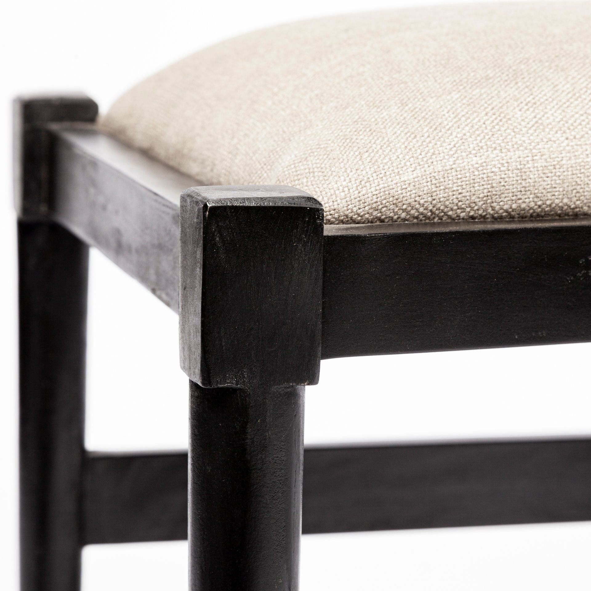 Front view of the Trixie I dining chair featuring a black-finished wooden frame with a curved wishbone-style backrest and dark taupe fabric seat