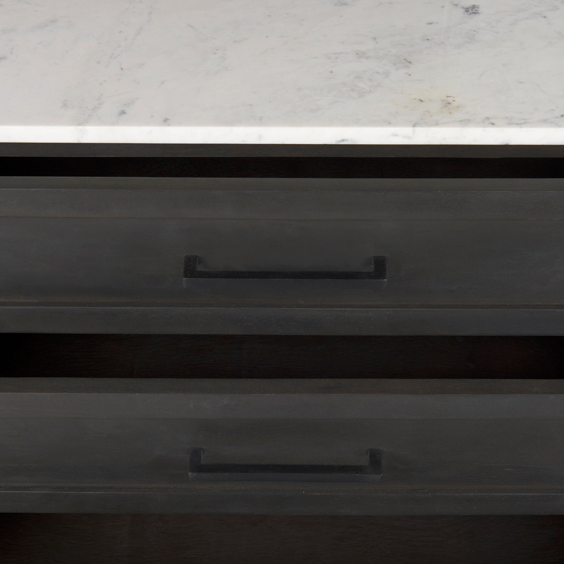 Front perspective view of the Gemma sideboard featuring a dark charcoal wood finish, a white marble top, and slim black metal legs
