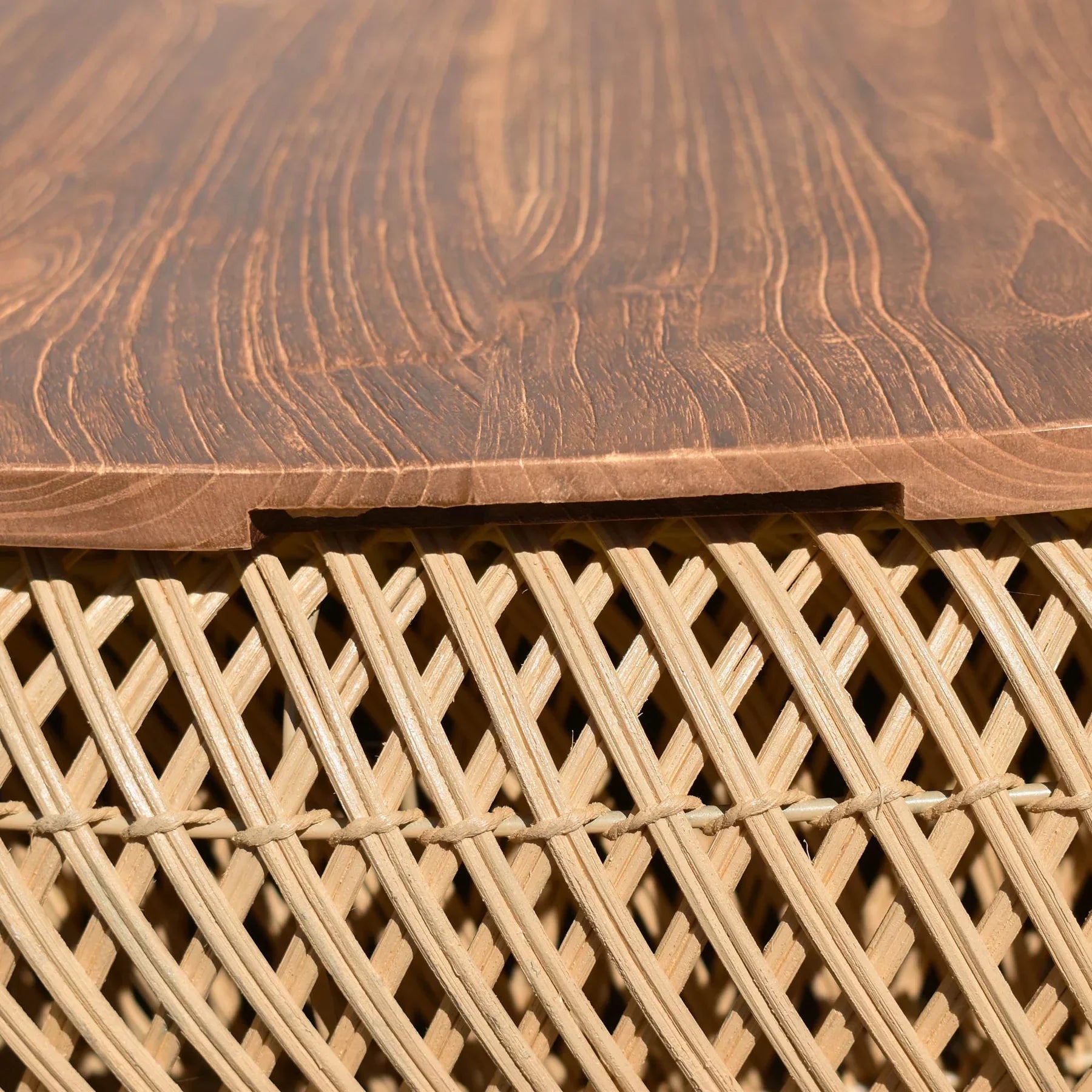 Front view of the large D-Bodhi Wave coffee table featuring a rounded woven abaca base in a natural finish with a solid recycled wood tabletop