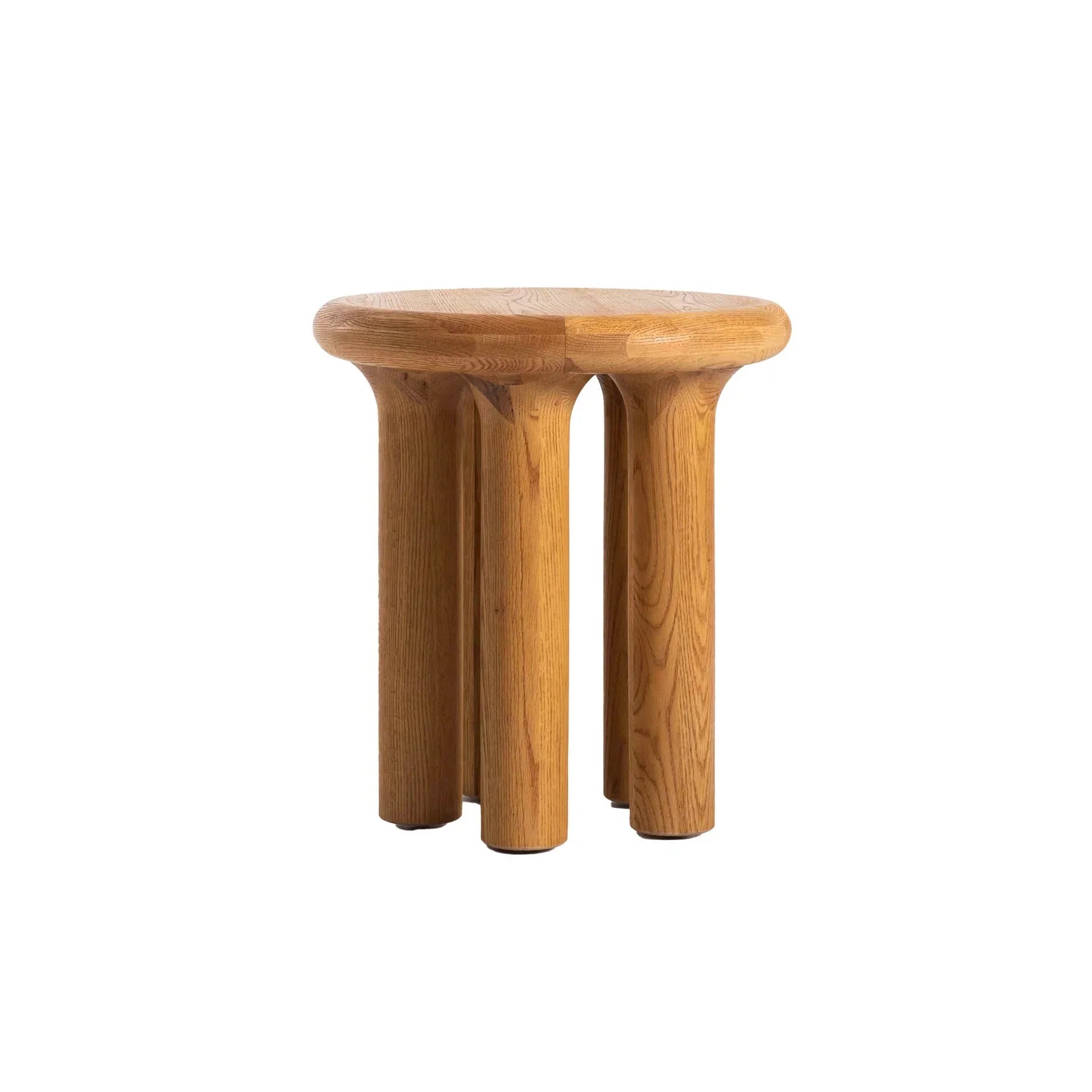 Front view of the Destiny side table featuring a thick circular oak top and four chunky cylindrical pedestal legs in a warm natural finish