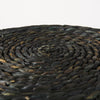 Macro detail shot showcasing the intricate texture and organic variations of the black dyed water hyacinth and cornhusk fibers