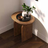 High-angle lifestyle shot featuring the Domingo table styled with a black decorative tray and candle in a modern interior