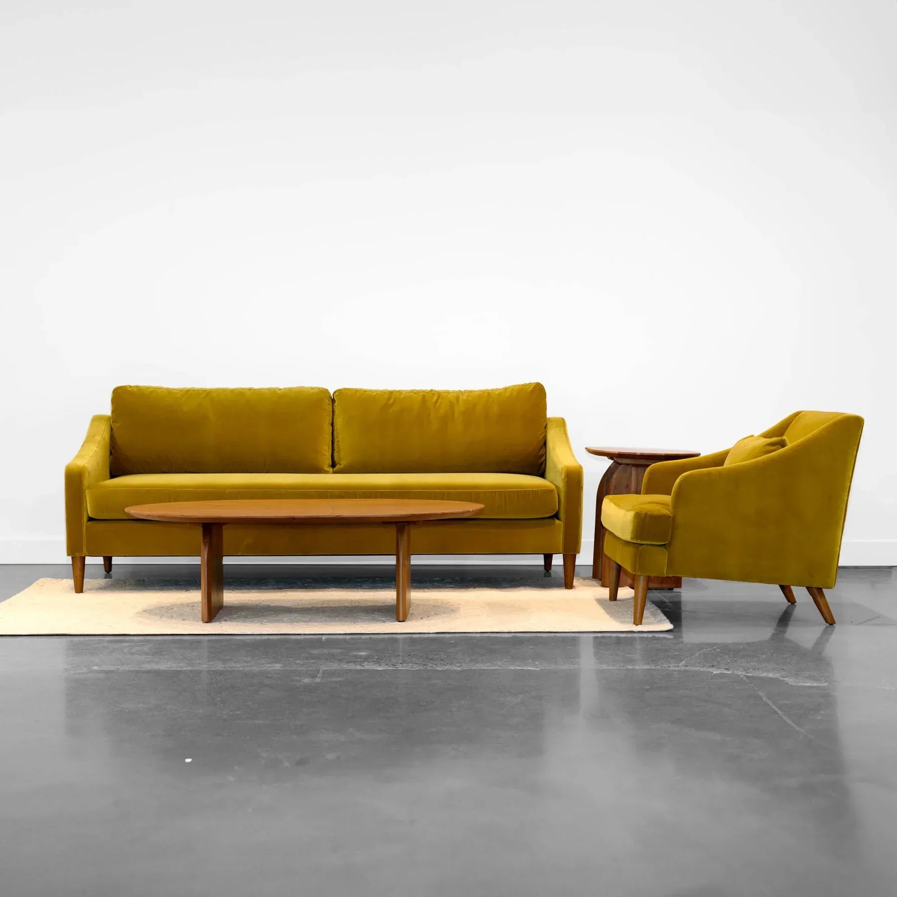 Full room view showing the Domingo coffee table paired with a matching yellow sofa and armchair suite