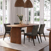 Studio lifestyle shot featuring the Domingo walnut table styled with four grey upholstered chairs in a bright dining room