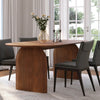 Close-up lifestyle shot featuring the table surface styled with a glass vase, candles, and elegant grey chairs