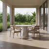 Studio lifestyle shot featuring the white marble Dream dining table styled with contemporary outdoor chairs in a bright minimalist patio setting