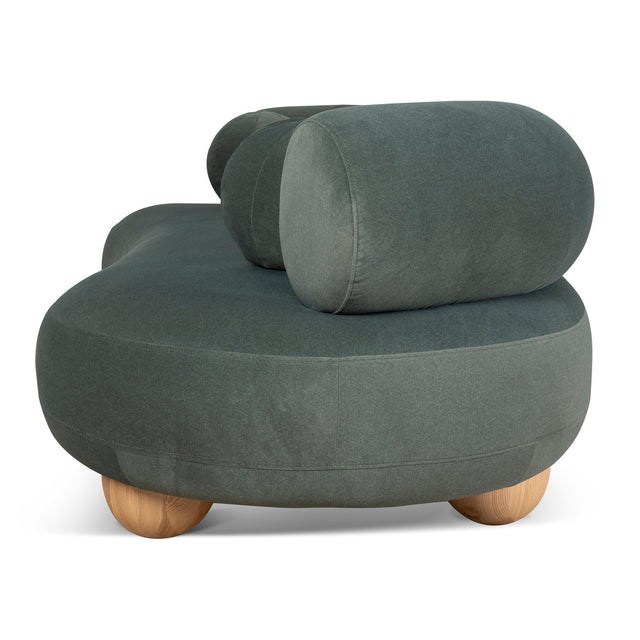 Ebba sofa in textured cream fabric with rounded arms and decorative circular pillows