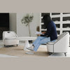 A person interacting with the black Ebony chair to demonstrate scale and seat height