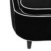 Close-up of the crisp white contrast piping against the premium black velvet upholstery