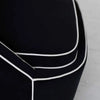 Detailed view of the precision stitching and curved lines on the black velvet frame