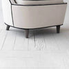 Close-up of the lower frame and legs of the cream velvet Ebony armchair