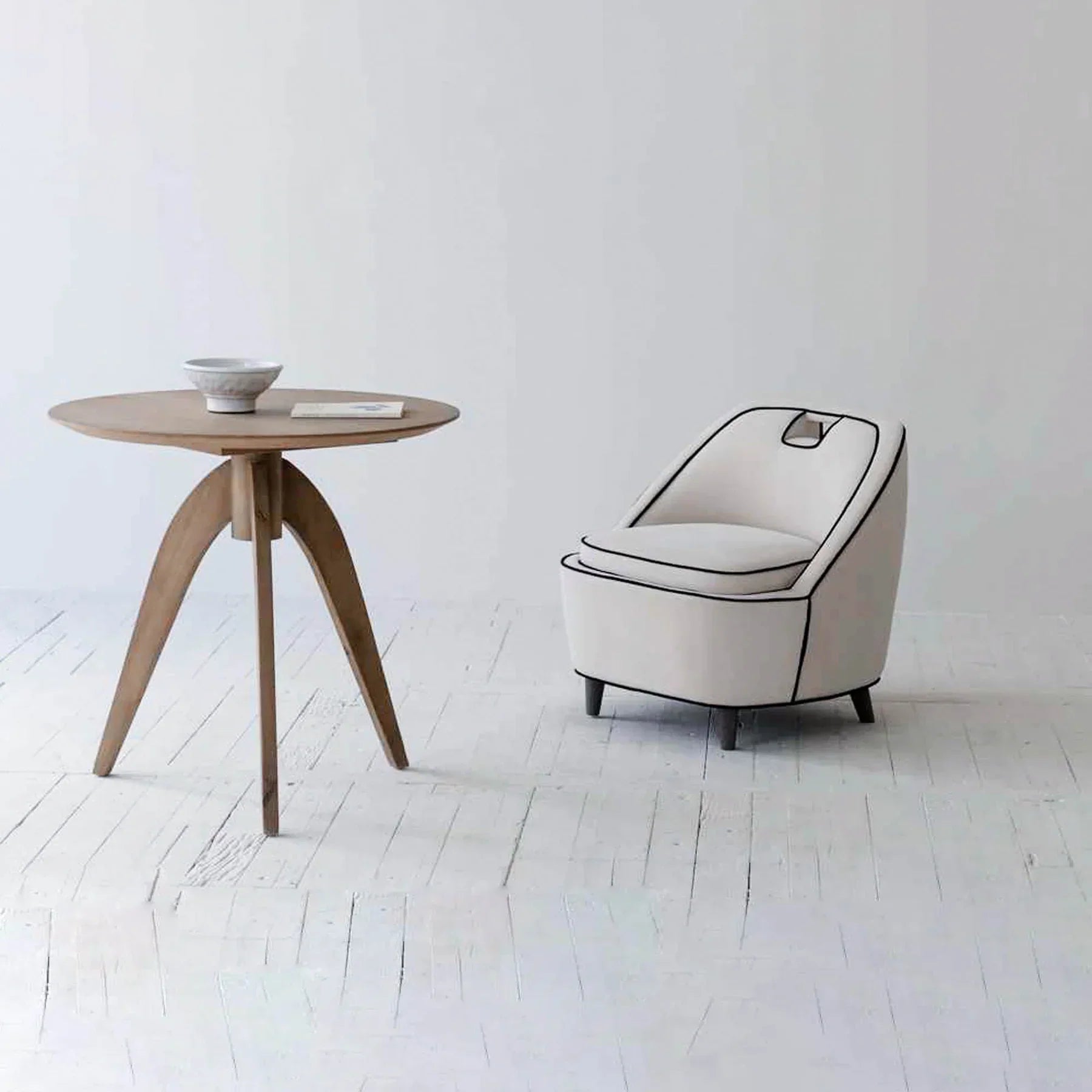 A person sitting in the cream Ebony chair in a large open-concept living space