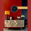 Lifestyle shot featuring the two-tone sideboard in a bold eclectic room with a red accent wall and modern decor