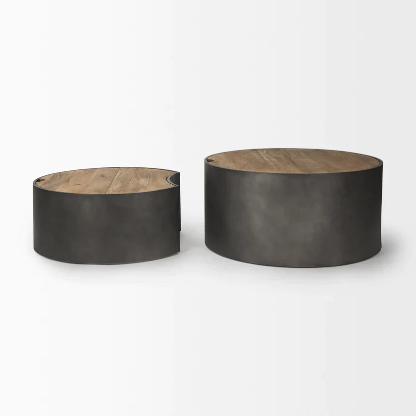 Front view of the Eclipse nesting coffee table set featuring two circular brown wood tops on dark gunmetal gray metal drum bases