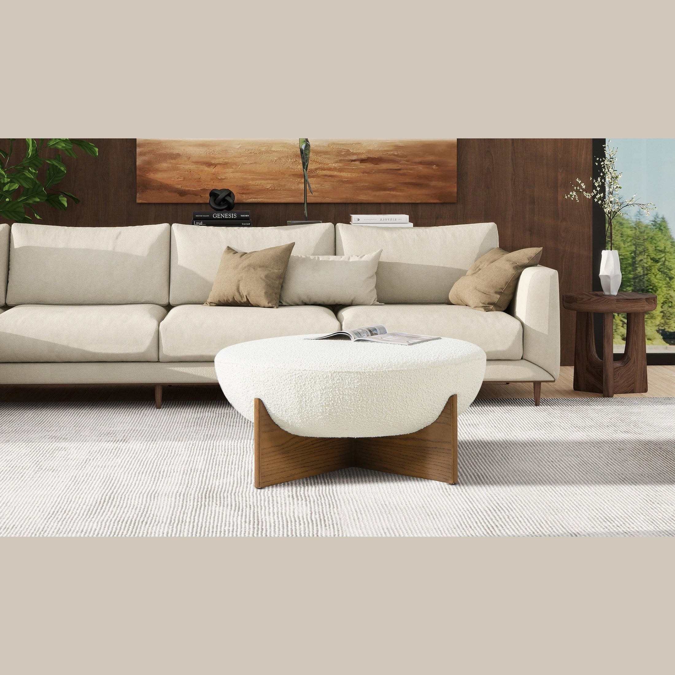 Front view of the Elara ottoman featuring a white bouclé bowl-shaped seat and a natural wood cross-base frame