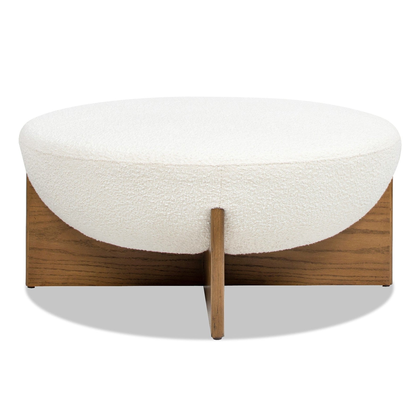 Front view of the Elara ottoman featuring a white bouclé bowl-shaped seat and a natural wood cross-base frame