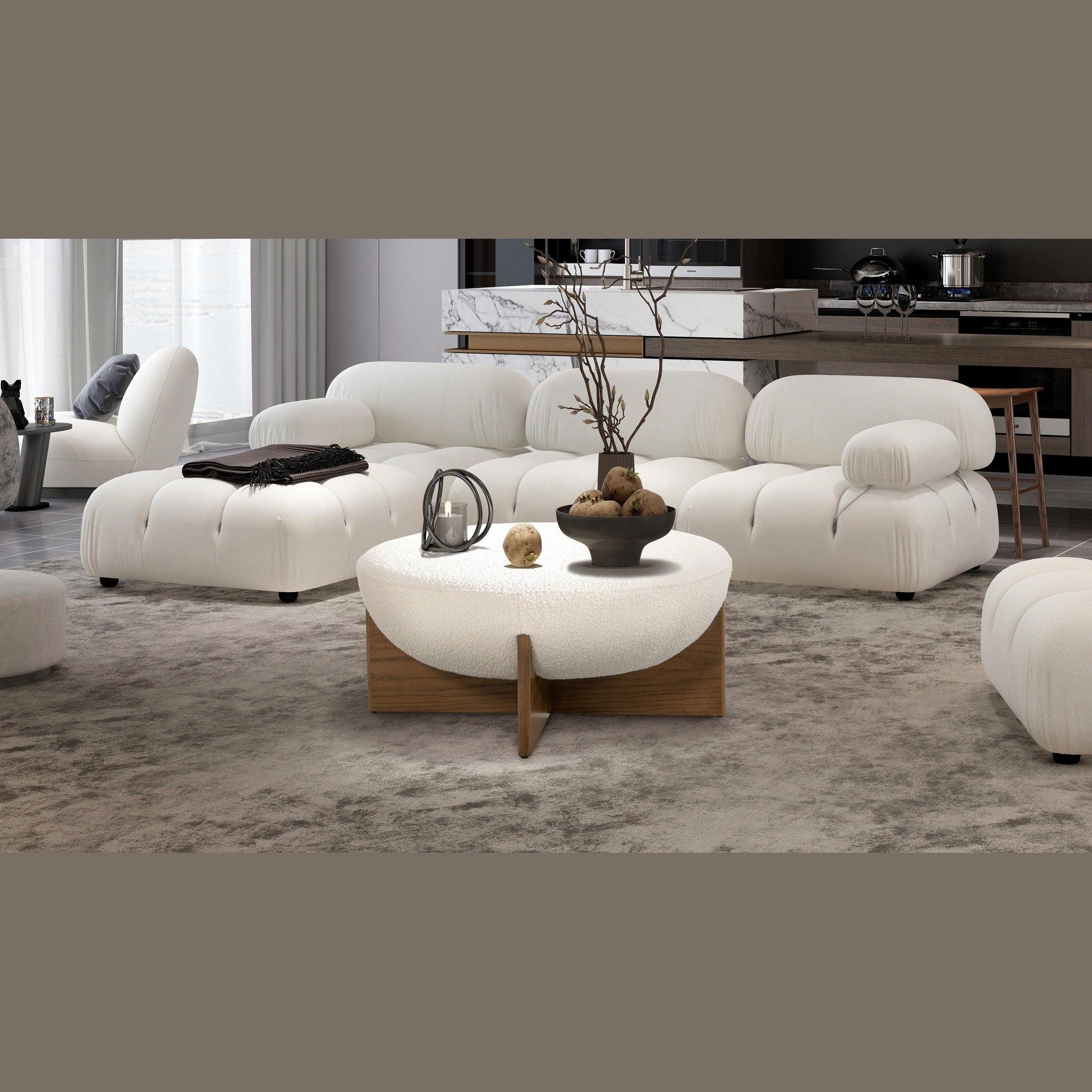 Front view of the Elara ottoman featuring a white bouclé bowl-shaped seat and a natural wood cross-base frame