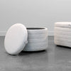 Perspective view showing the Elio platinum ottoman with the lid removed to reveal the internal storage compartment