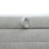 Close-up shot of the discrete platinum fabric pull tab designed for lifting the removable storage lid