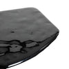 Macro close-up focusing on the liquid-like reflective quality and subtle organic ripples of the high-shine black tabletop surface