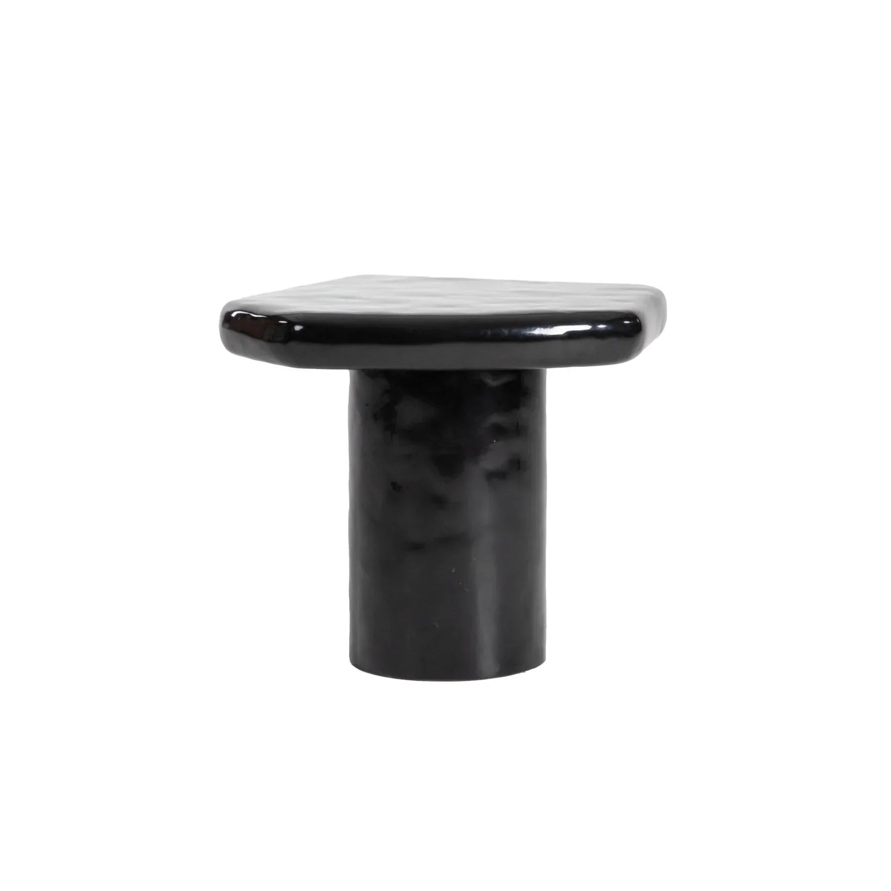 High-angle profile shot emphasizing the clean lines and modern sculptural form of the high-gloss black accent table