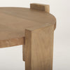 Close-up shot focusing on the top of the block leg where it sits flush with the circular tabletop surface showcasing the wood grain
