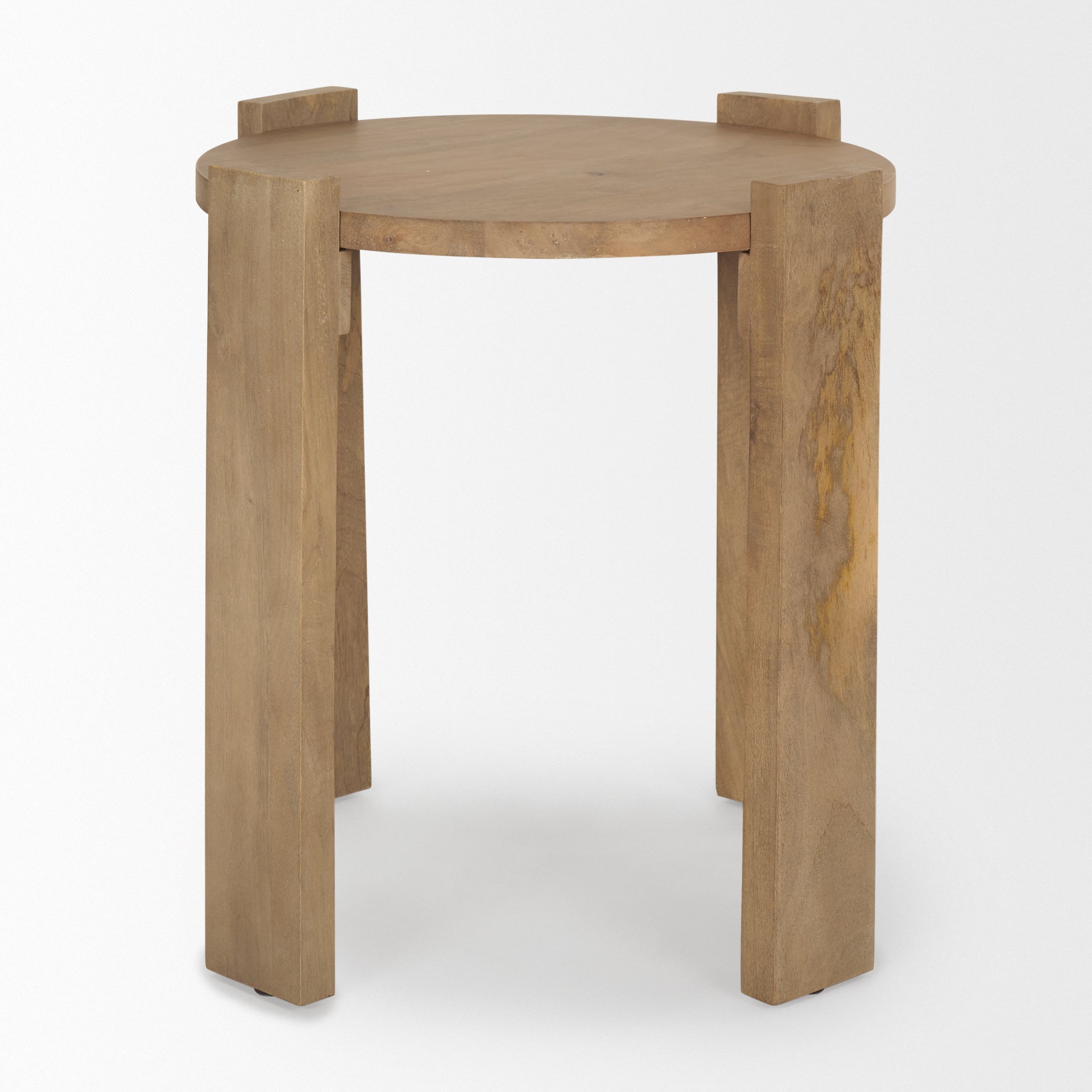 Three-quarter view of the Evelyn round side table in light brown wood featuring a flat circular top and three inset block-style legs