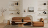 Lifestyle shot featuring the Evelyn table in a bright modern living room with a brown sofa and neutral decor