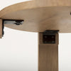 Underside view of the table showing the black metal brackets and hardware used to secure the solid wood legs to the tabletop