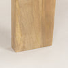 Macro shot highlighting the substantial thickness and natural wood texture of the slab leg construction