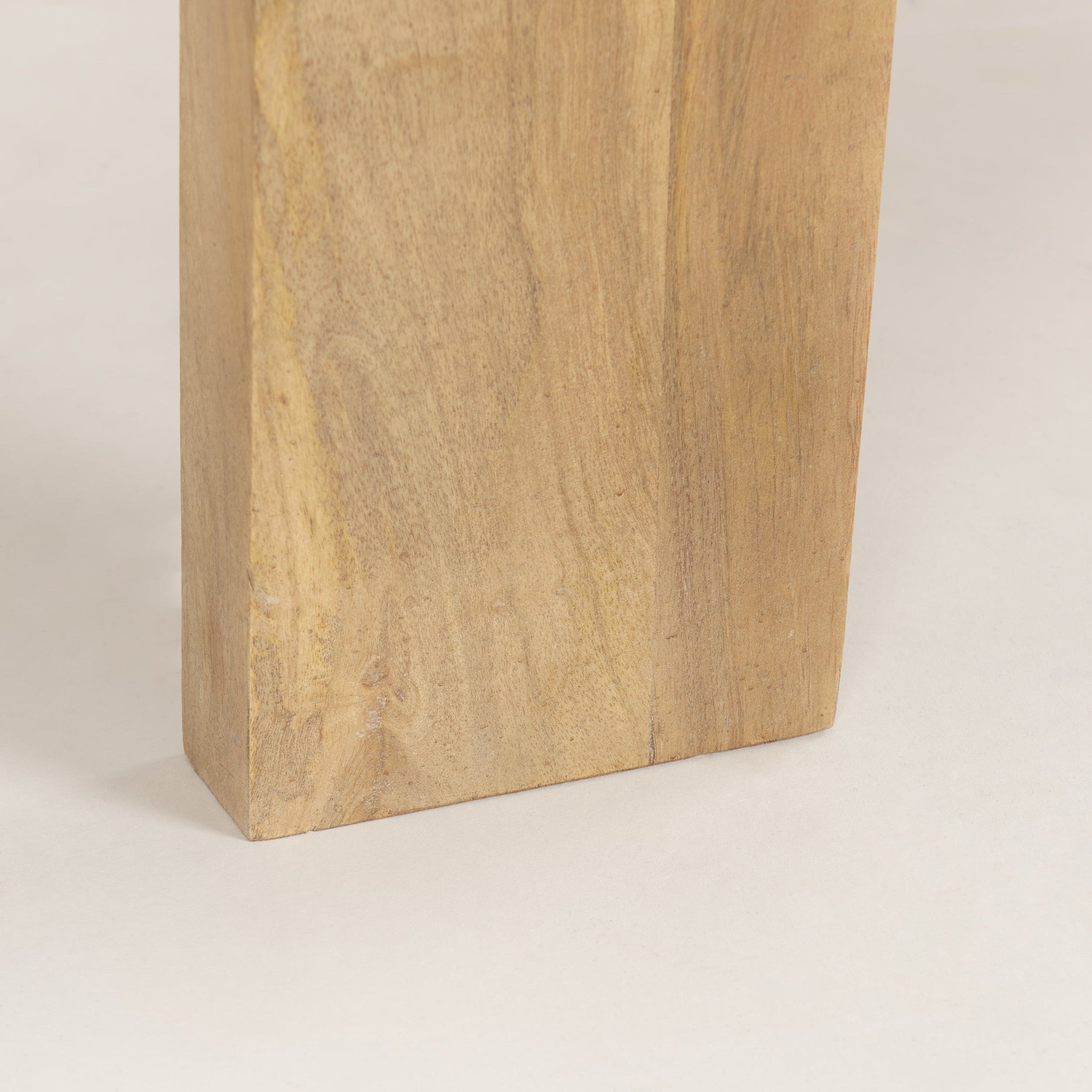 Macro shot highlighting the substantial thickness and natural wood texture of the slab leg construction