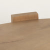 Detailed view of the seamless interface where the wide slab legs meet the curved oblong tabletop