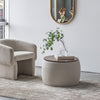 Lifestyle shot of the Fleur chair in buff styled in a minimalist room with a matching ottoman and neutral rug