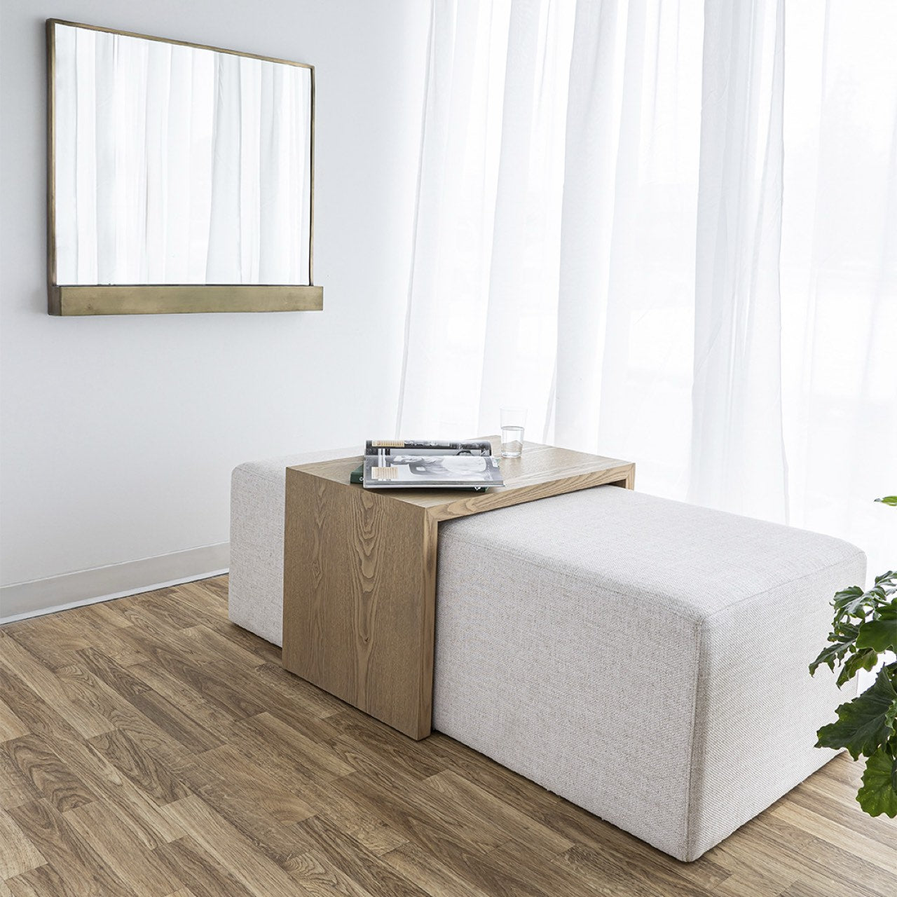 Front view of the Forest coffee ottoman featuring a cream upholstered rectangular bench with a nested blonde oak waterfall table