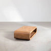 Perspective lifestyle shot showcasing the low-profile design and storage functionality in a gallery-style space