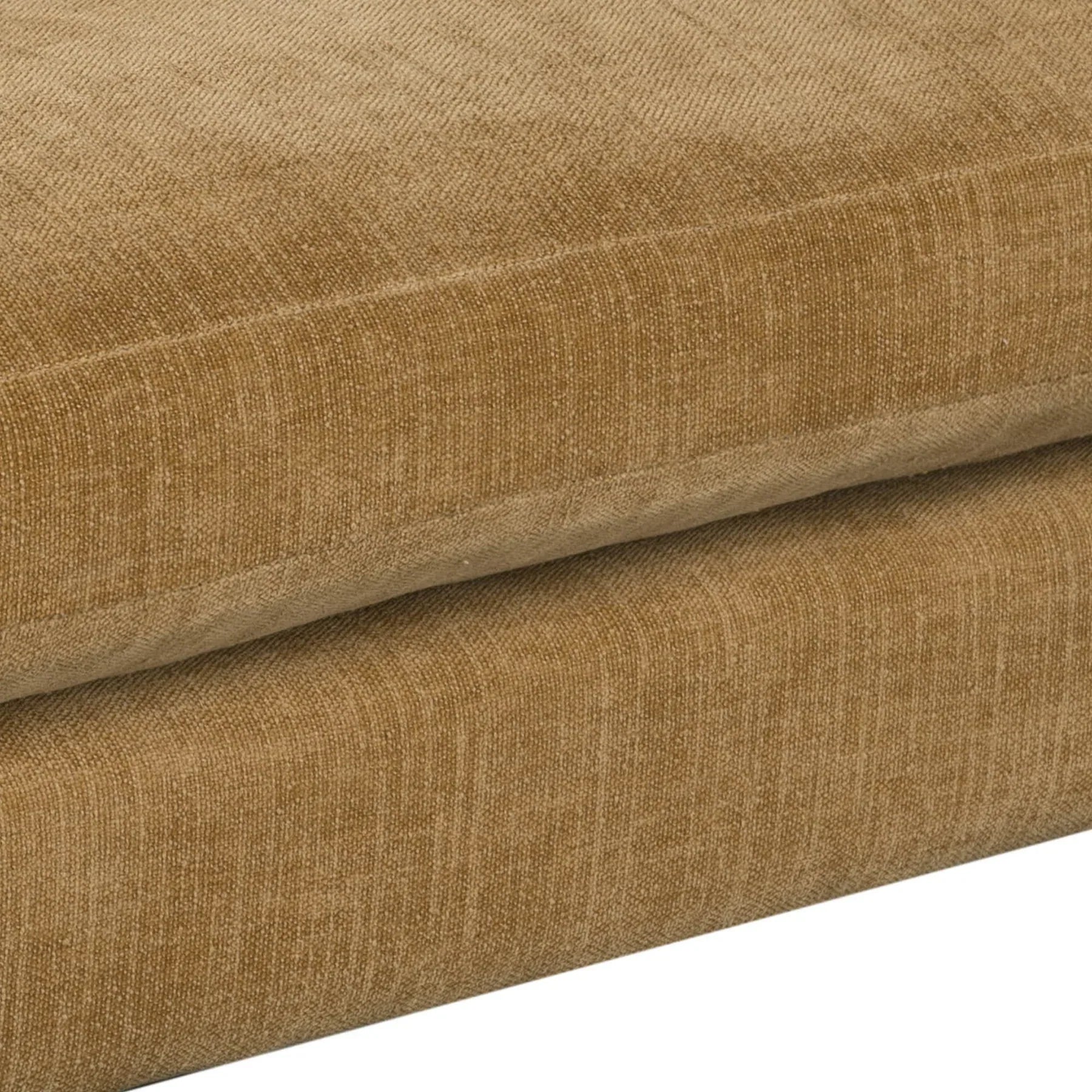 Close-up of the plush seat cushions on the honey brown sofa