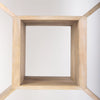 Straight-on view from inside an octagonal compartment highlighting the uniform blonde wood texture and depth