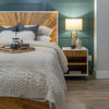 High-angle perspective view showcasing the full sunburst pattern on the footboard and internal slat system