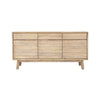 Front perspective view of the Gia sideboard featuring natural wood construction with horizontal textured paneling and three top drawers