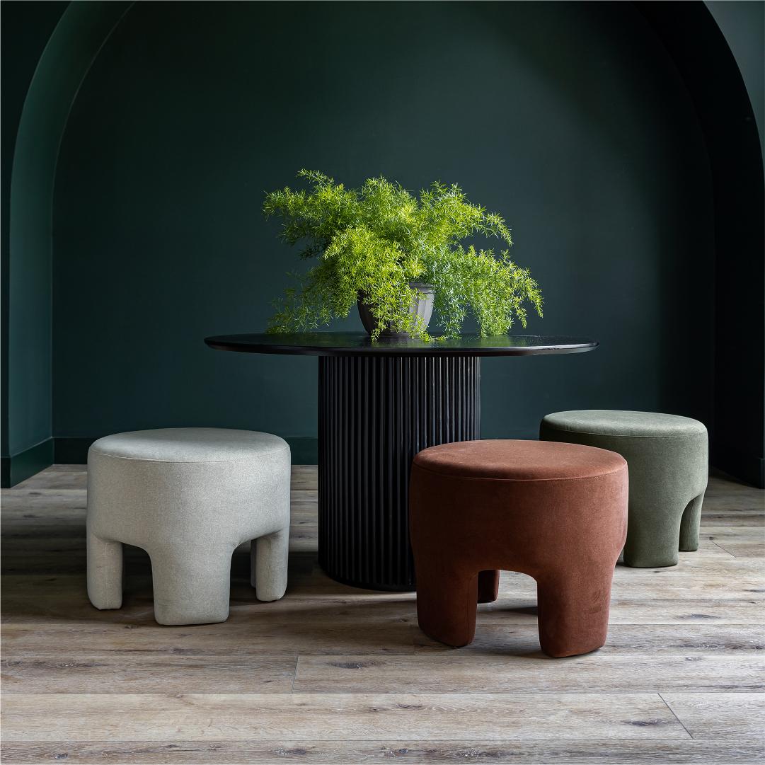 Front three-quarter view of the Ginger mushroom-shaped ottoman featuring rich chestnut brown velvet upholstery