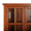 Close-up shot focusing on the upper section of the glass-front doors and the natural distressed wood grain