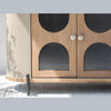 Macro shot focusing on the vertical grey fluted texture and the arched reeded glass door panels with white circular pulls