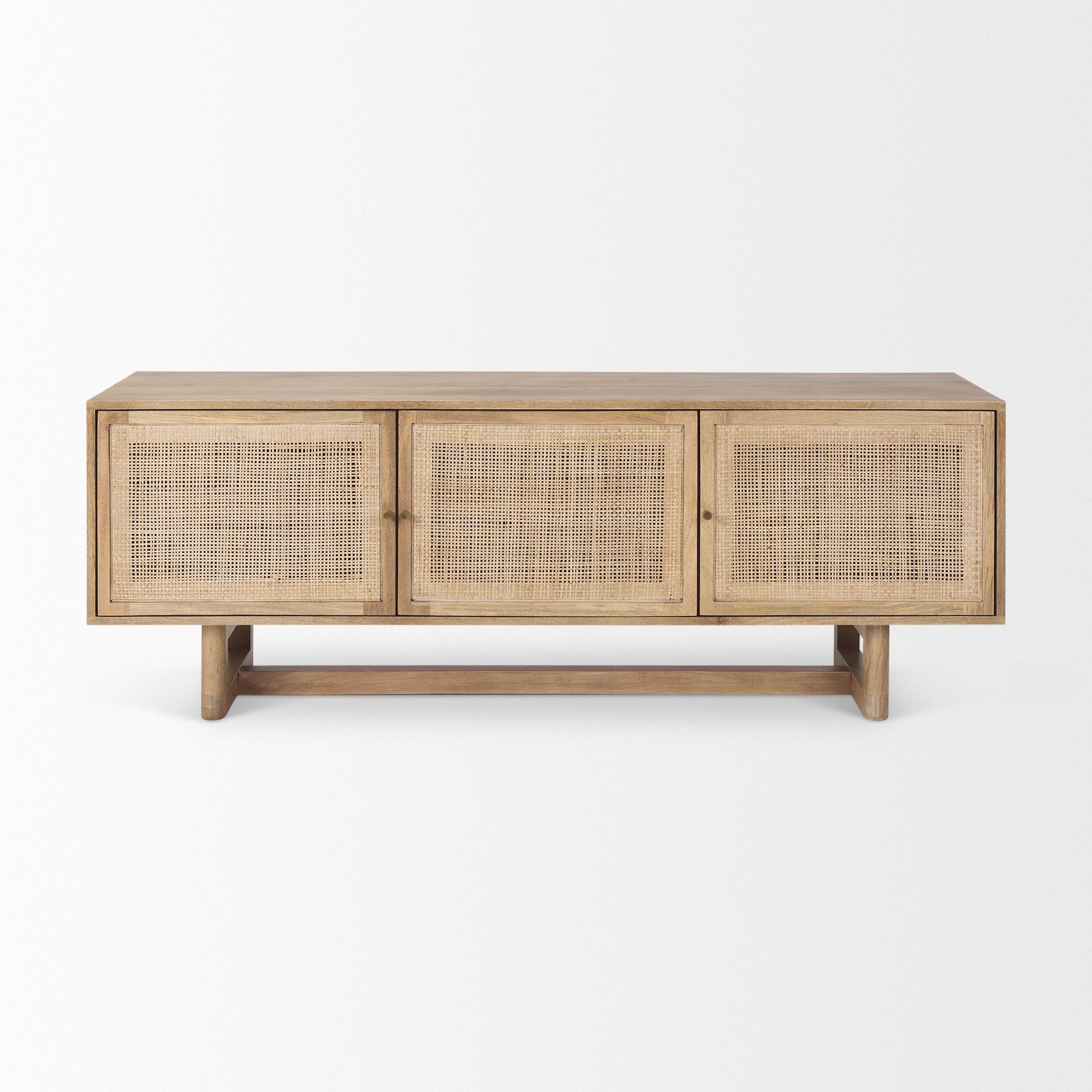 Front view of the Grier media unit in natural light mango wood featuring three doors with woven rattan cane inserts and a minimalist T-base frame