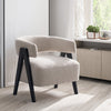 The Gunnar Boucle Chair styled in a bright, modern living room setting near a window.